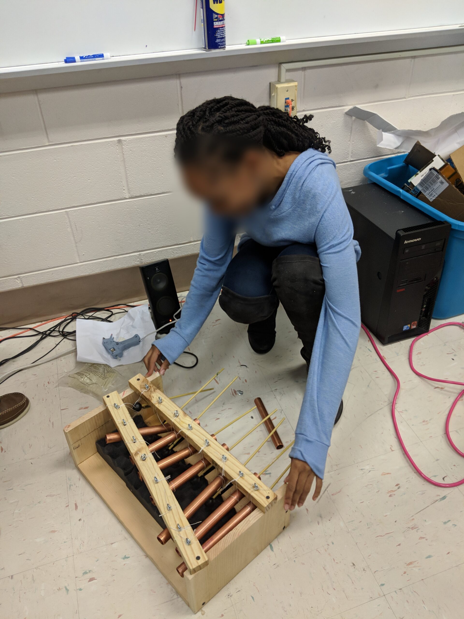 Student Working with Musical Instrument in Class