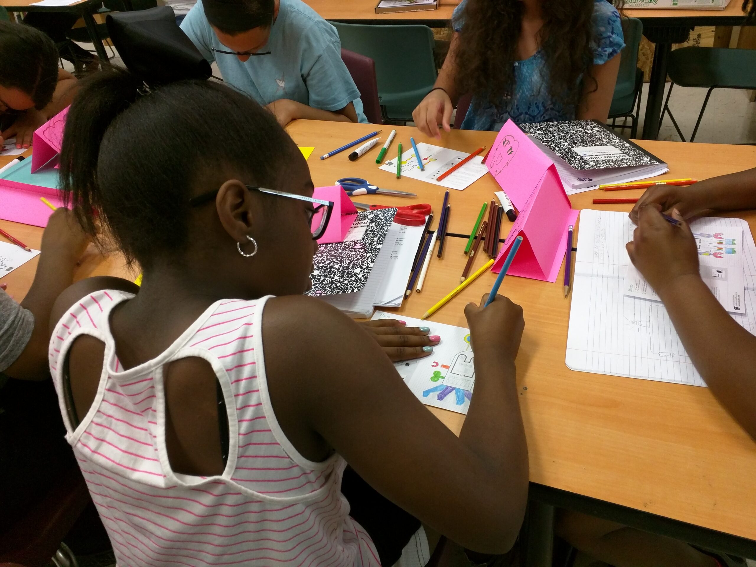 Students decorating circuits with colorful pencils during a classroom project